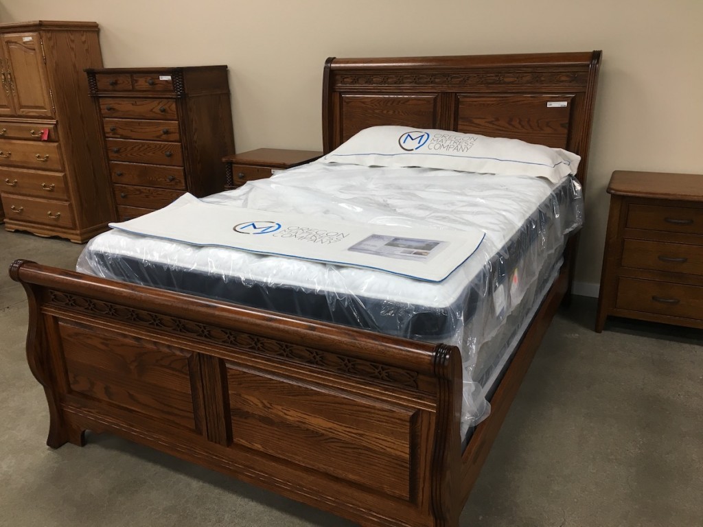 Amish sleigh bed with a twist of pine cone accents in your choice of finsh and wood